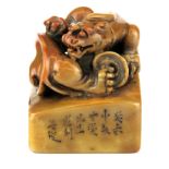 A Chinese carved stone scholars seal mounted with a dragon, 5.5 x 5.5 x 7cm.