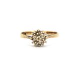 A 9ct yellow gold diamond set cluster ring, (J).