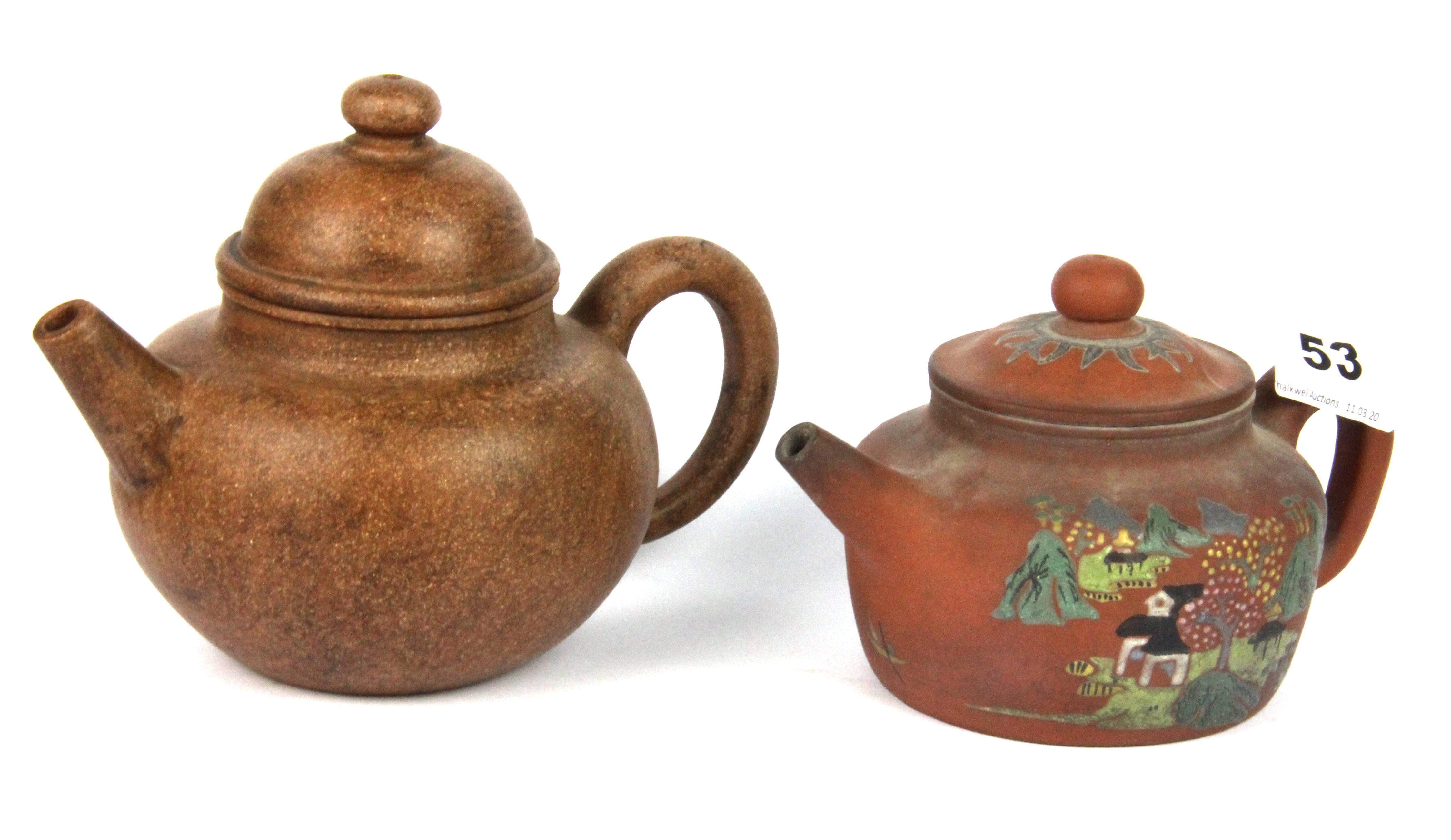 Two Chinese Yixing terracotta teapots, one with enamelled decoration, tallest 12cm.