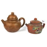 Two Chinese Yixing terracotta teapots, one with enamelled decoration, tallest 12cm.
