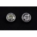 A pair of 9ct white gold diamond set stud earrings, approx. 0.40ct overall.