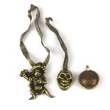 A group of three Tibetan bronze and hammered copper amulets, largest H. 4cm.