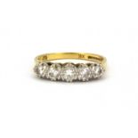 An 18ct yellow and white gold ring set with five brilliant cut graduated diamonds, (O.5).