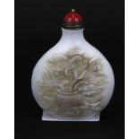 A Chinese carved milk glass snuff bottle with gilt and hardstone stopper, H. 7.5cm.