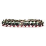 A 925 silver bracelet set with rubies, sapphires and emeralds, (two stones missing) L. 18cm.