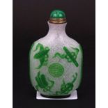 A Chinese carved Peking cameo glass snuff bottle featuring the eight scared Buddhist symbols with