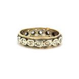 A 9ct yellow and white gold (stamped 9ct) stone set full eternity ring, (M).