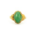 A yellow metal (tested high carat gold) ring set with a 3.9ct cabochon cut natural untreated jadeite