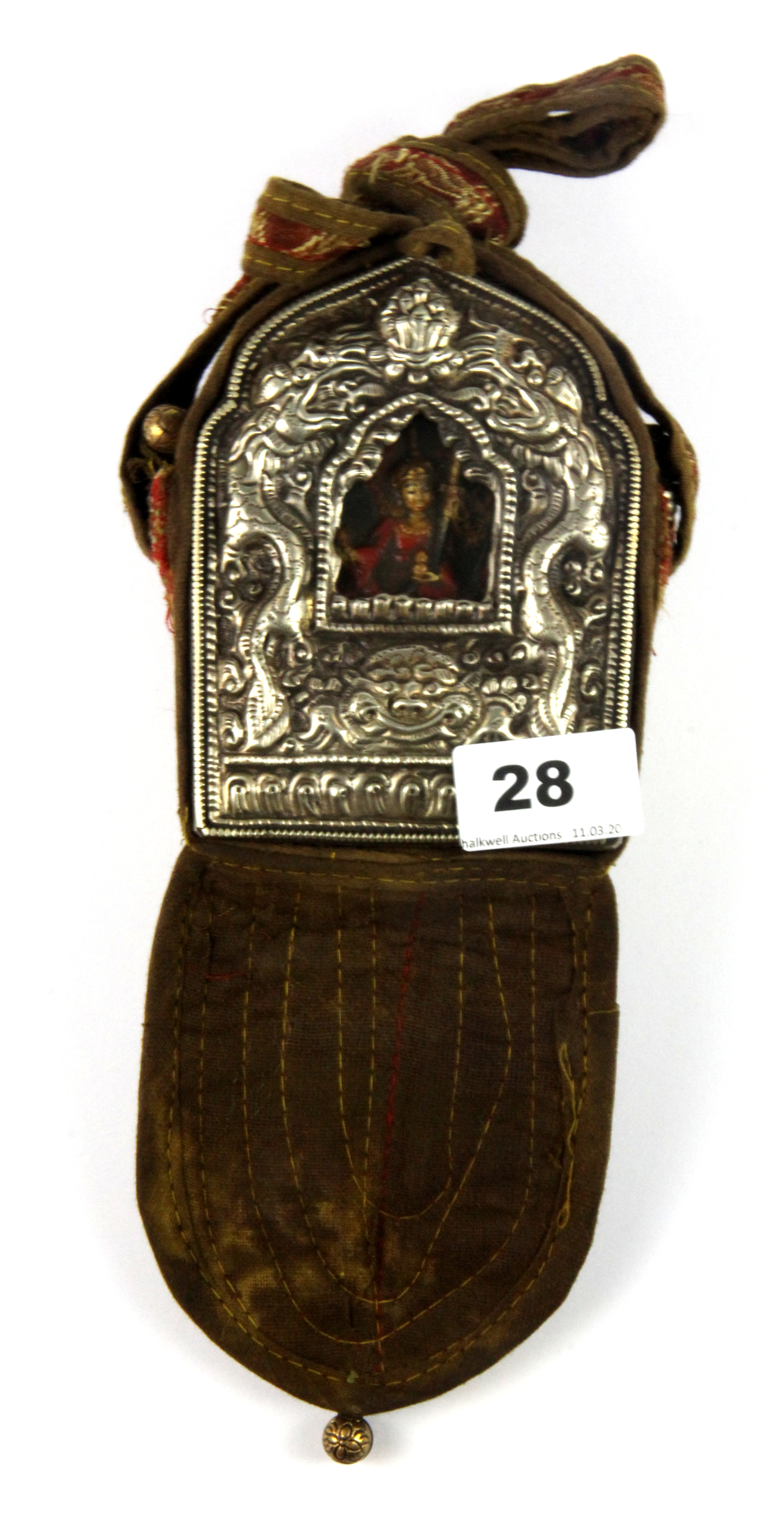 A Tibetan copper and hammered white metal ga'u containing a painted clay deity and prayers/teachings