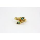 An 18ct yellow gold ring set with pear cut emeralds and diamonds, (N.5).