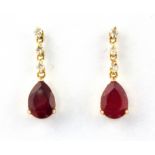 A pair of 18ct yellow gold pear cut ruby and diamond set drop earrings, L. 1.6cm.