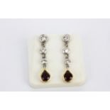 A pair of 18ct white gold drop earrings set with pear cut rubies and brilliant cut diamonds, L. 2.