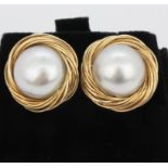 A pair of 18ct yellow gold (stamped 18k) pearl set stud earrings, Dia. 1.8cm.