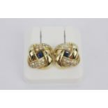 A pair of 18ct white gold stud earrings set with step cut sapphires and diamonds, L. 1.5cm.