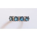 A 9ct yellow gold oval cut blue topaz and diamond set ring, (M).