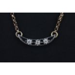 A 9ct yellow and white gold necklace set with three old cut diamonds, L. 46cm.