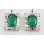 A pair of 18ct white gold stud earrings set with large oval cut untreated Columbian emeralds