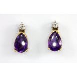 A pair of 9ct yellow gold stud earrings set with a pear cut amethyst and brilliant cut diamonds,