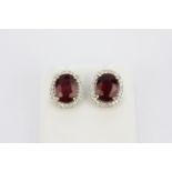 A pair of 18ct white gold natural untreated ruby and diamond set cluster earrings, L.2.3cm.