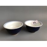 A pair of hand painted blue glazed Chinese porcelain tea bowls. D. 9.5cms H. 5cms. Condition