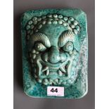 An interesting Chinese ceramic door guardian head with turquoise crackle glaze. H. 22cms W. 17cms D.