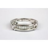 A 9ct white gold ring set with baguette cut diamonds, (L).