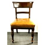 An early 19th century mahogany and leather upholstered hall chair with sabre legs.