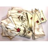 Two large embroidered table cloths and matching napkins.