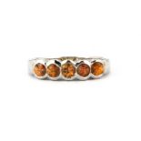 A 9ct white gold citrine set half eternity ring, (O).