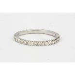 An 18ct white gold (stamped 750) diamond set full eternity ring, approx. 0.87ct overall, (M.5).