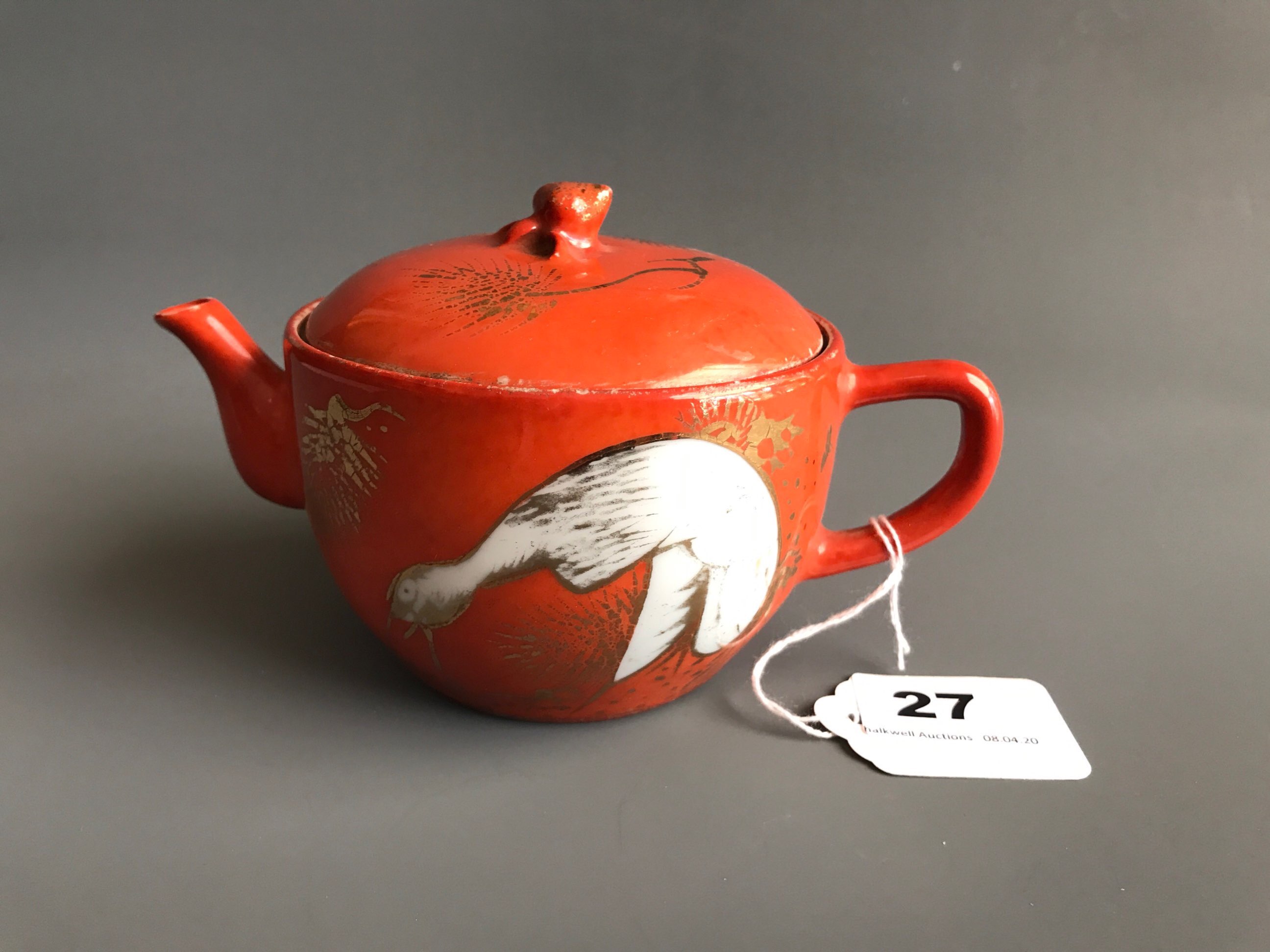 A mid 20thC Chinese Republican period porcelain teapot with orange and gilt decoration of a crane.