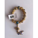 A strand of good quality enamelled gilt bronze wrist type prayer beads. Bead dia. 1.4cms.