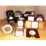 A group of mixed vintage alarm clocks.