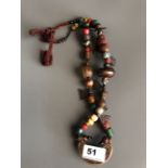 A Tibetan re-strung pilgrim's necklace of sacred glass, bone, ceramic, stone and bronze objects