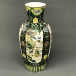 An early to mid 20th Century Chinese porcelain vase hand painted with wucai colours in panels of