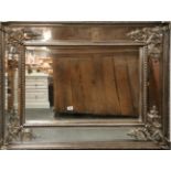 An large ornate silvered framed mirror, size 91 x 120cm.