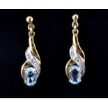 A pair of 9ct yellow gold blue topaz and diamond set drop earrings, L. 2.2cm.