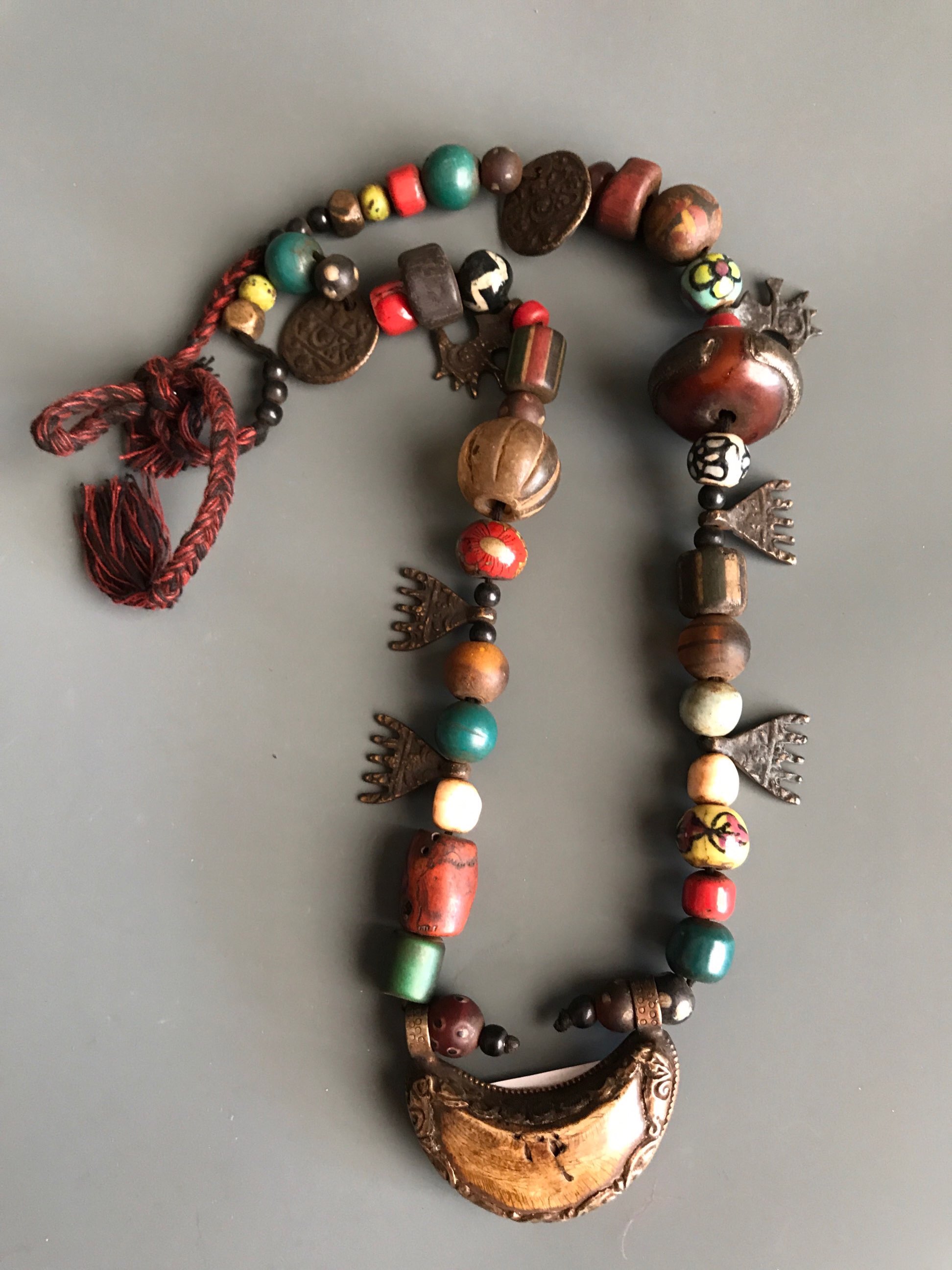 A Tibetan re-strung pilgrim's necklace of sacred glass, bone, ceramic, stone and bronze objects - Image 2 of 4