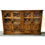 A carved oak and leaded glass display cabinet, 140 x 30 x 85cm.