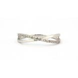 A 9ct white gold diamond set crossover ring, (N.5).