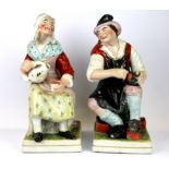 A pair of large early 19th Century Staffordshire pottery figures of the cobbler and his wife, H.