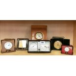 Five leather cased vintage clocks, largest 22 x 15cm.