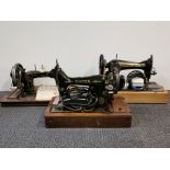 Three vintage sewing machines.