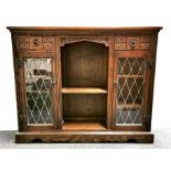 A carved oak and leaded glass display cabinet, 120 x 28 x 100cm.