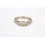 A 950 platinum ring set with a princess cut centre diamond flanked by brilliant cut diamonds, (I.