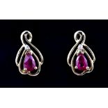 A pair of 9ct yellow gold ruby and diamond set stud earrings, L. 1.2cm