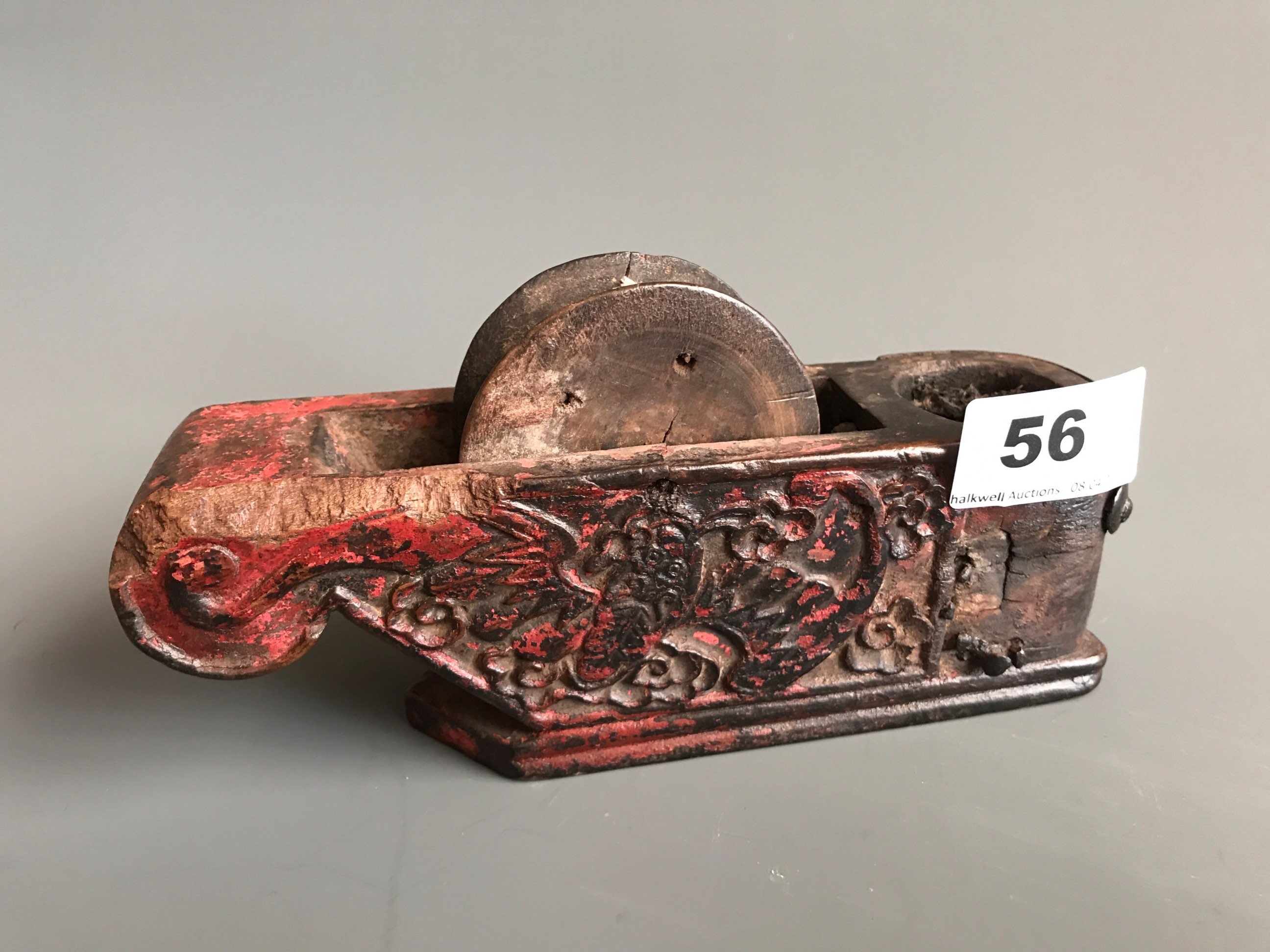 A 19th/ early 20thC Chinese carved wooden feng shui marker or plumb line carved with a stylised