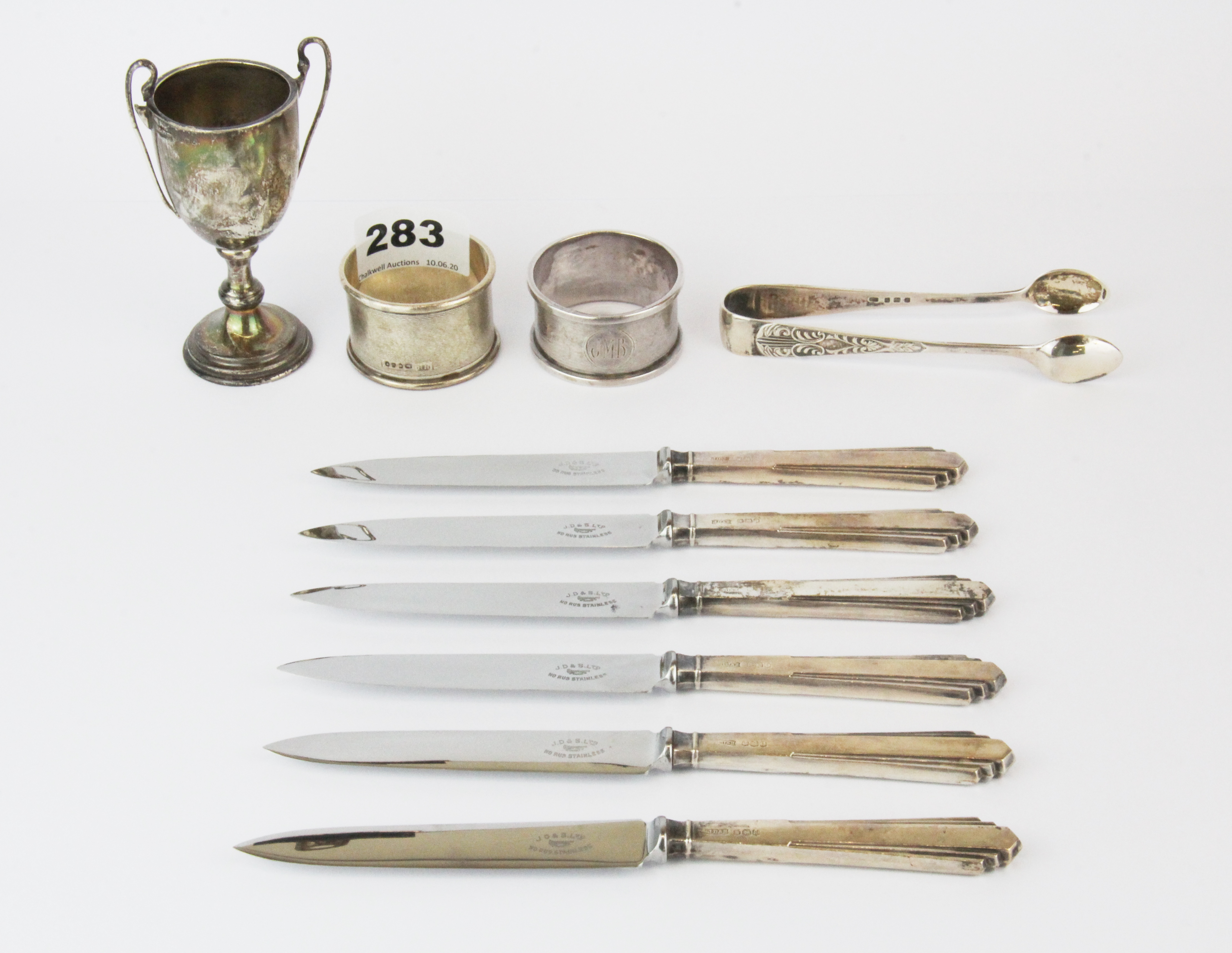 Two hallmarked silver napkin rings, hallmarked silver sugar tongs and a 1936 miniature hallmarked