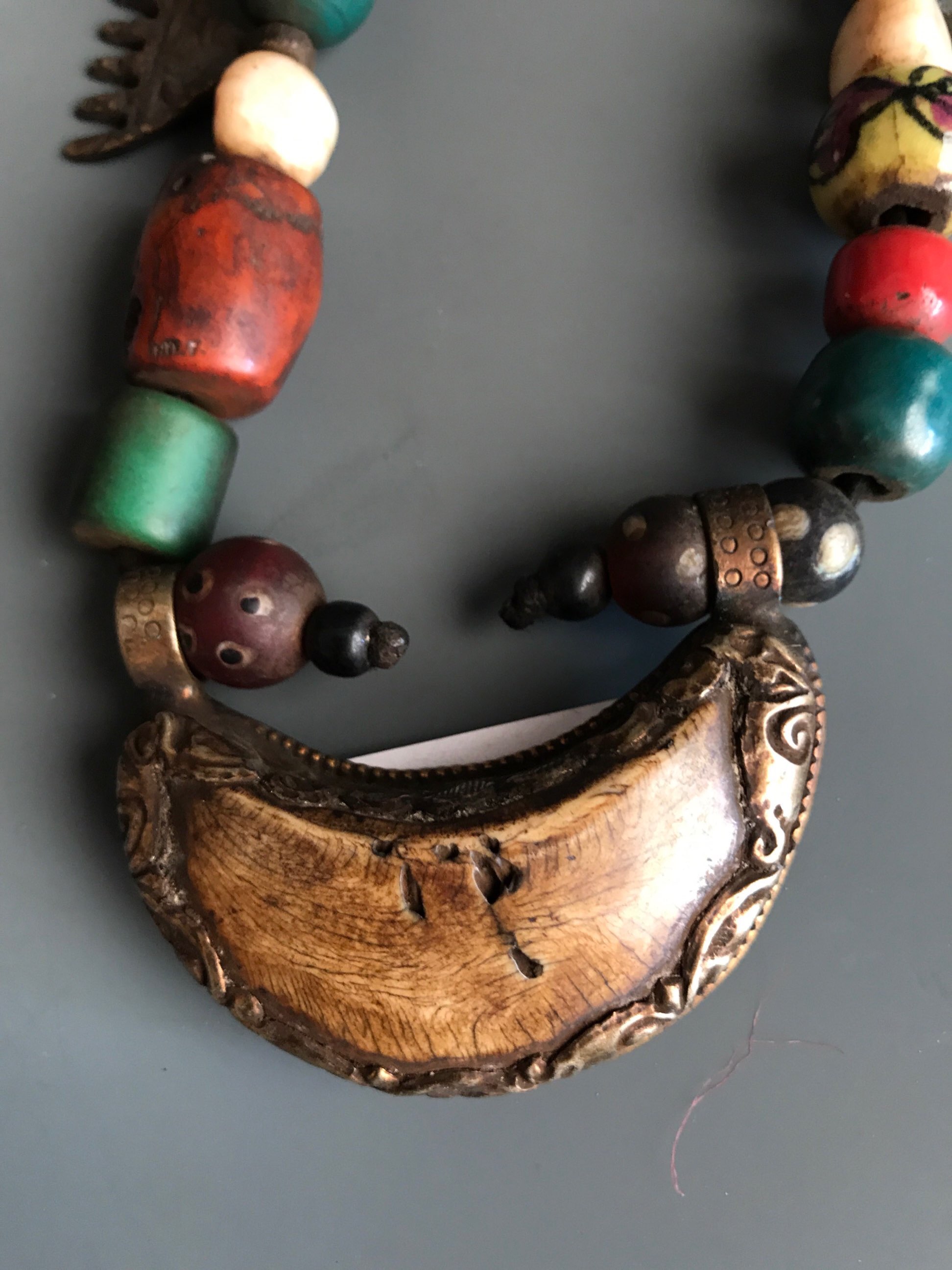 A Tibetan re-strung pilgrim's necklace of sacred glass, bone, ceramic, stone and bronze objects - Image 3 of 4