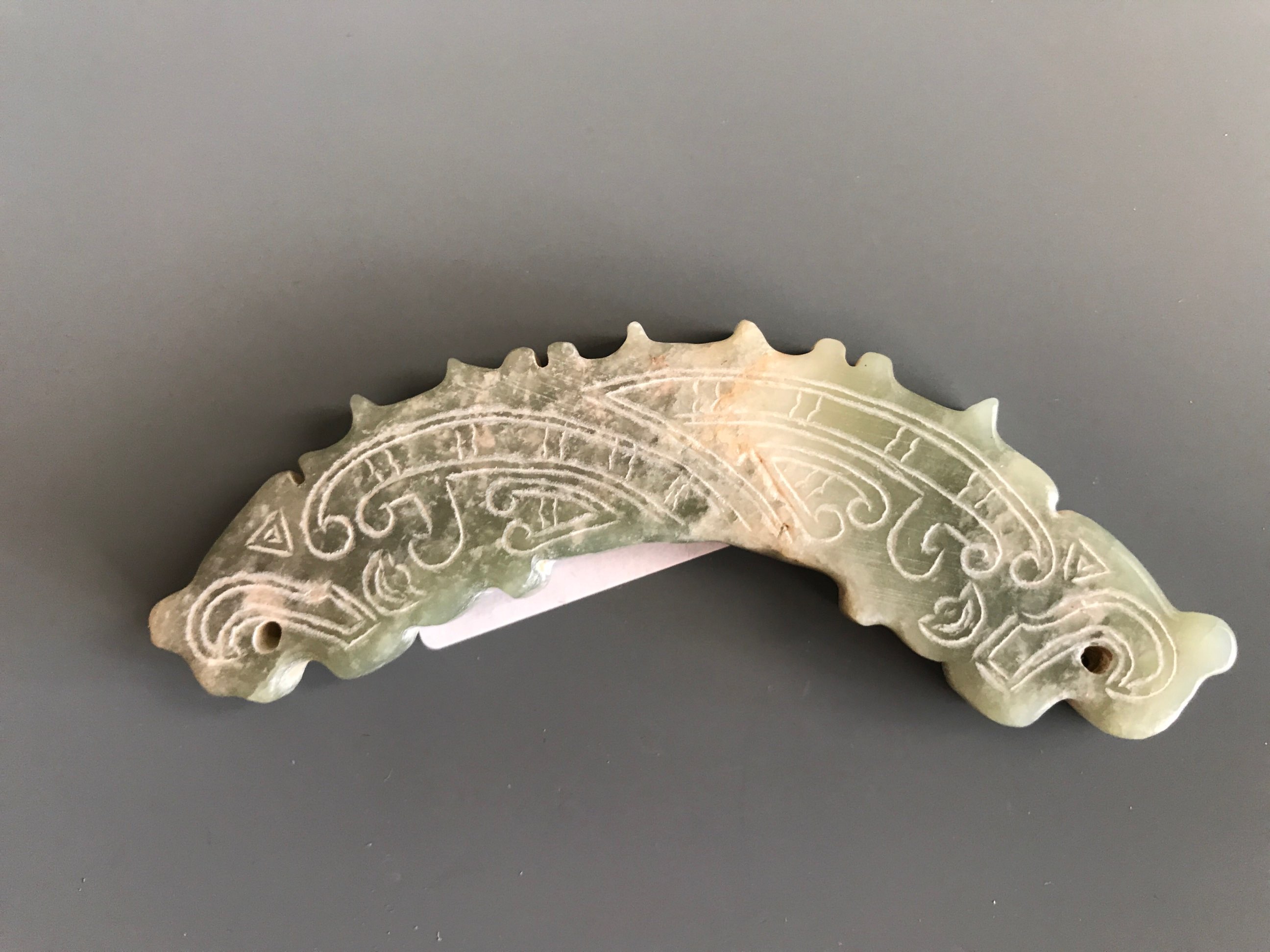 A Chinese archaic form carved mixed colour nephrite jade amulet. W. 11cms. Condition good with no - Image 2 of 2